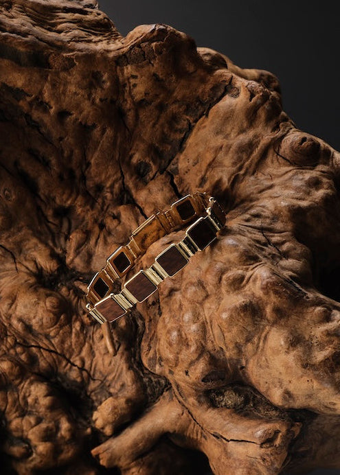 Wooden and gold Bracelet on piece of wood