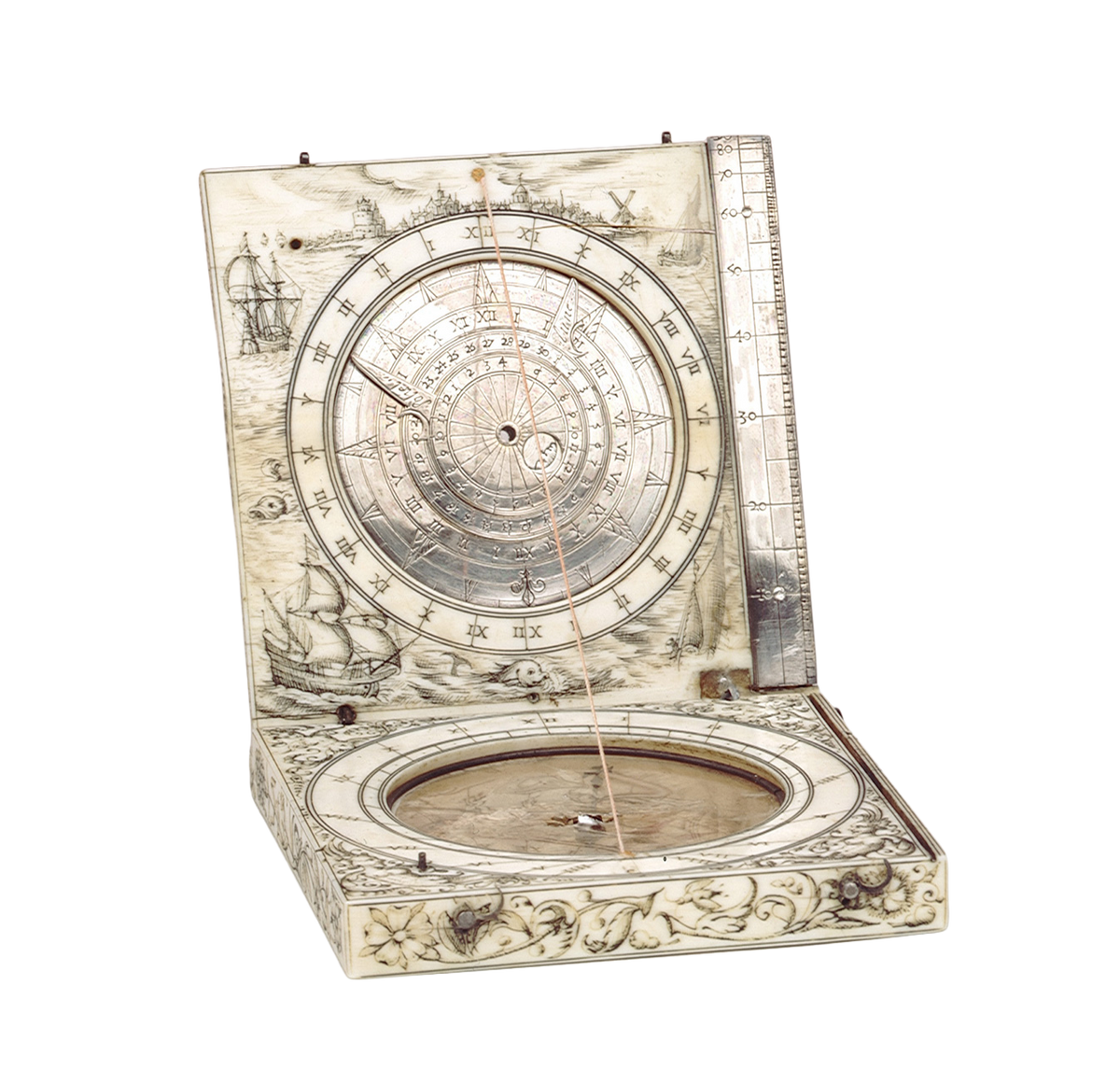 An antique compass and sun dial with an open lid displaying a detailed celestial dial and nautical illustrations