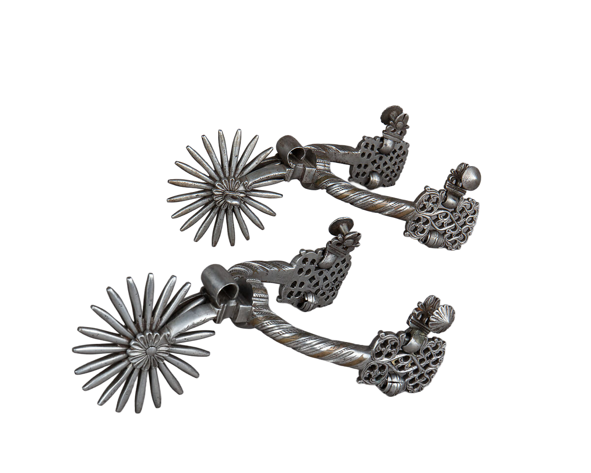Two ornate silver-toned metal spurs with starburst-shaped heads and decorative textured bodies, shown on a plain white background.